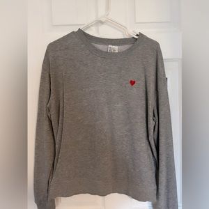 Divided grey sweatshirt with red heart.